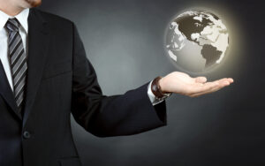 Custom broker holds hologram of the world globe in the palm of his left hand. 