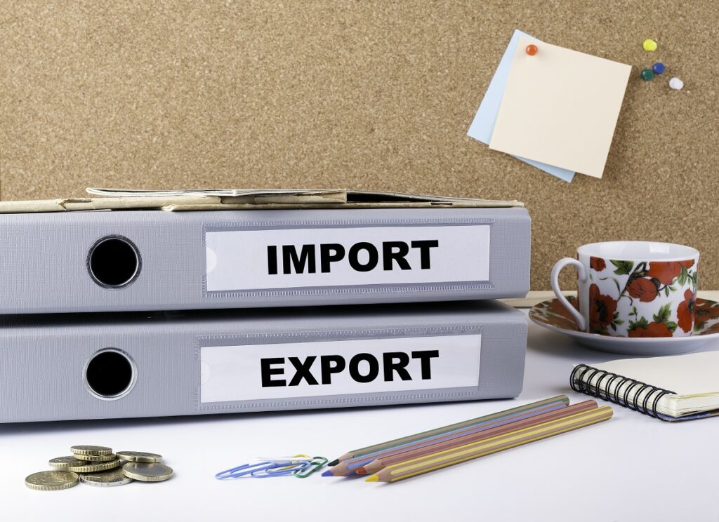 gray binders labeled import and export holding records of customs transactions